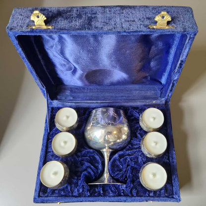 Silver goblet with six white candles in a blue velvet box
