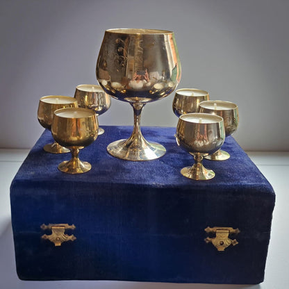 Set of goblets on a blue velvet box against a gray background
