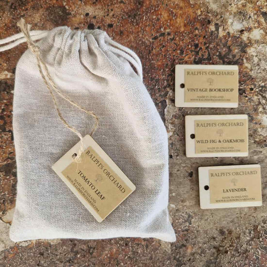 Ralph's Orchard product packaging with a drawstring bag and tags on a textured surface