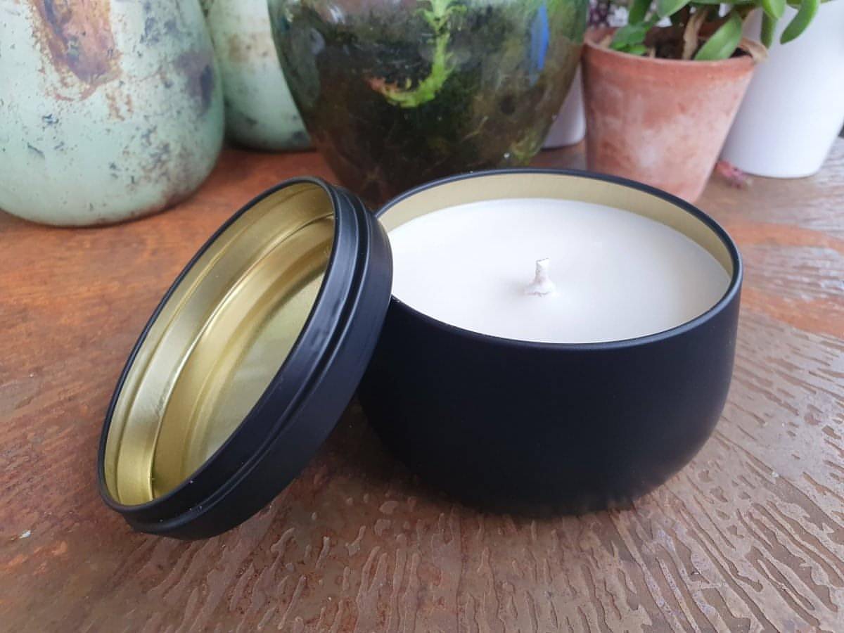 unscented candle in black lidded tin