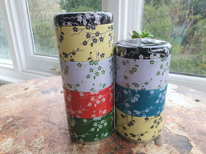 Stacked scented candles in floral tins